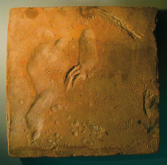Saalburgmuseum: Fußabdruck eines Kindes auf einem Ziegel mit Fluch in griechischer Sprache: „Oreus und Monos sind hundsföttische Kaffern (= Schurken), mehr noch als Laurentius“