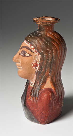 Parfumölflakon in Form einer reich geschmückten und gekleideten Frau , Figurengefäß, Ton, um 560 v. Chr.,